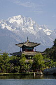 China, Yunnan Province, Shangri-la region  Lijiang, Black Dragon Pool Park, temple and bridge  Jade Dragon Snow Mountain in background