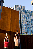 Couple doing Yoga with urban background