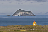 View of a small inhabited island on the South West coast of Iceland from Fáskrúðsfjörður, on a summer day