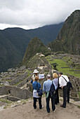 Peru, Machu Picchu, guide lecturing tourists