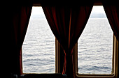 Curtain at the window of a ferry with view at the croatian coast, Split, Croatia, Europe
