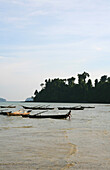Sea gypsy, Moken boy dragging boat to the shore, Mergui Archipelago, Andaman Sea, Myanmar, Burma, Asia