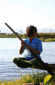 Intha girl rowing on water way, Inle Lake, Shan State, Myanmar, Burma, Asia