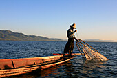 Intha fisherman with fish trap in the evening light, Inle Lake, Shan State, Myanmar, Burma, Asia