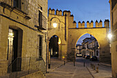 Jaen town gate at dusk in Populo square, Baeza. Jaen province, Andalucia, Spain