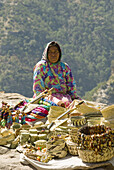 Tarahumara Indian woman selling handwoven baskets and other handicrafts, Copper Canyon, near Divisadero, Mexico