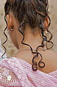The hair of a young girl at her coming of age ceremony (quincinera).
