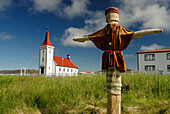 Kópasker church-museum with scarecrow at fore, Iceland