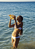 Woman with conch shell, Sosua, Dominican Republic