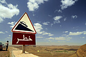 Traffic sign at Tinififft-pass under clouded sky, Draa valley, South Morocco, Morocco, Africa
