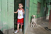 HONDURAS  Boy and dog   The slum barrio of Chamelecon, San Pedro Sula