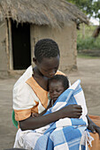 SOUTH SUDAN  Early morning scene of a family of Yei  Lilias Nighty, 19, with her baby Gabriel