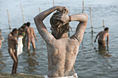 Sadhu covered in ash bathing in River Ganges at Kumba Mela festival, Allahabad, Uttar Pradesh, India