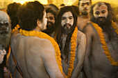 Naga Sadhus preparing for bathing in The holy river Ganges at Kumbh Mela Festival. Allahabad, Uttar Pradesh, India