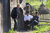 Men chatting in village, Maramures, Romania