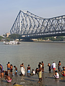 bathers under the Howrah Bridge in Calcutta