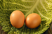 Two eggs over a Cabbage green leaf