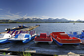pedal boats at lake Hopfensee with Tannheim range in background, Allgaeu, Swabia, Bavaria, Germany