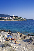 People sunbathing at the coast of Primosten, Croatian Adriatic Sea, Dalmatia, Croatia, Europe