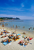 People sunbathing on the beach under blue sky, Golfo della Spezia, Italian Riviera, Liguria, Italy, Europe