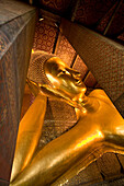 Head of Reclining Buddha. Wat Pho temple. Bangkok. Thailand