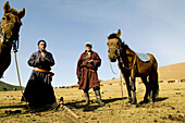Mongolian nomads enjoy a cigarette break in the vast Mongolian grasslands