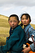 Young Mongolian nomads on their horses