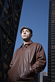 Portrait of a young man in an urban setting at dusk, San Francisco, California, USA