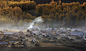 Cooking smoke rising above the frontier town of Womuk in Northwest Xinjiang, China