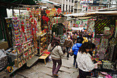 A narrow and steep streets lined with small shops in the Central District, Hong Kong, China