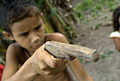 Child with toy gun in one of the Amazone communities, Cametá. Brazil.