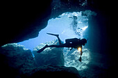 scuba diver diving in cave