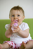 Baby girl (8 month) with a bottle, Vienna, Austria
