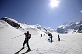 Skiers on slope, Morteratsch valley, Bernina range, Grisons, Switzerland