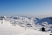 Ski slope and ski lift at Kitzbuehel Alps in the sunlight, Tyrol, Austria, Europe