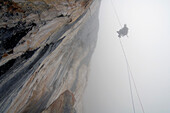 Climber roping in the fog, Tyrol, Austria, Europe