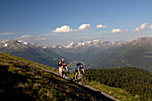 Three people on a mountain bike tour near Blaser, near Steinach am Brenner, Wipptal, Tyrol, Austria