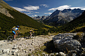 Couple on a mountain bike tour, MTB, mountainbiking near Tschierv, near Ofenpass, Sesvenna Mountain Range, Grisons, Switzerland