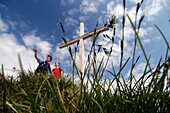 Hikers at a summit cross at the Allgaeu Alps, Bavaria, Germany, Europe