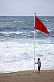 Red flag on Zurriola beach, San Sebastian. Guipuzcoa, Basque Country, Spain