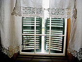 Minorcan window with Richelie embroidered curtain, Spain