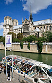 Tourist boat and Notre Dame cathedral. Paris. France.