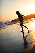 Girl on the beach at sunset, Es Arenals, Formentera, Balearic Islands, Spain