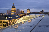 View over glass roof to German and French cathedral in the evening, Berlin, Germany
