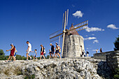 Tourists at Daudets windmill under blue sky, Bouches-du-Rhone, Provence, France, EuropeVisitors
