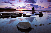 Saltwick Bay with Black Nab rock at low tide at dusk in summer, Whitby, Yorkshire, UK, England