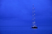 Yacht on water at night, Antibes, Cote d'Azur, France