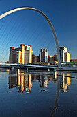 The Baltic Arts Centre framed by the Millennium Bridge, Gateshead, Tyne and Wear, UK, England