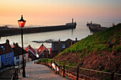 View of 199 Abbey Steps above Whitby Harbour at dusk, Whitby, Yorkshire, UK, England
