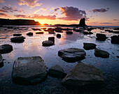 Black Nab rock at low tide at sunset, Saltwick Bay, Yorkshire, UK, England
